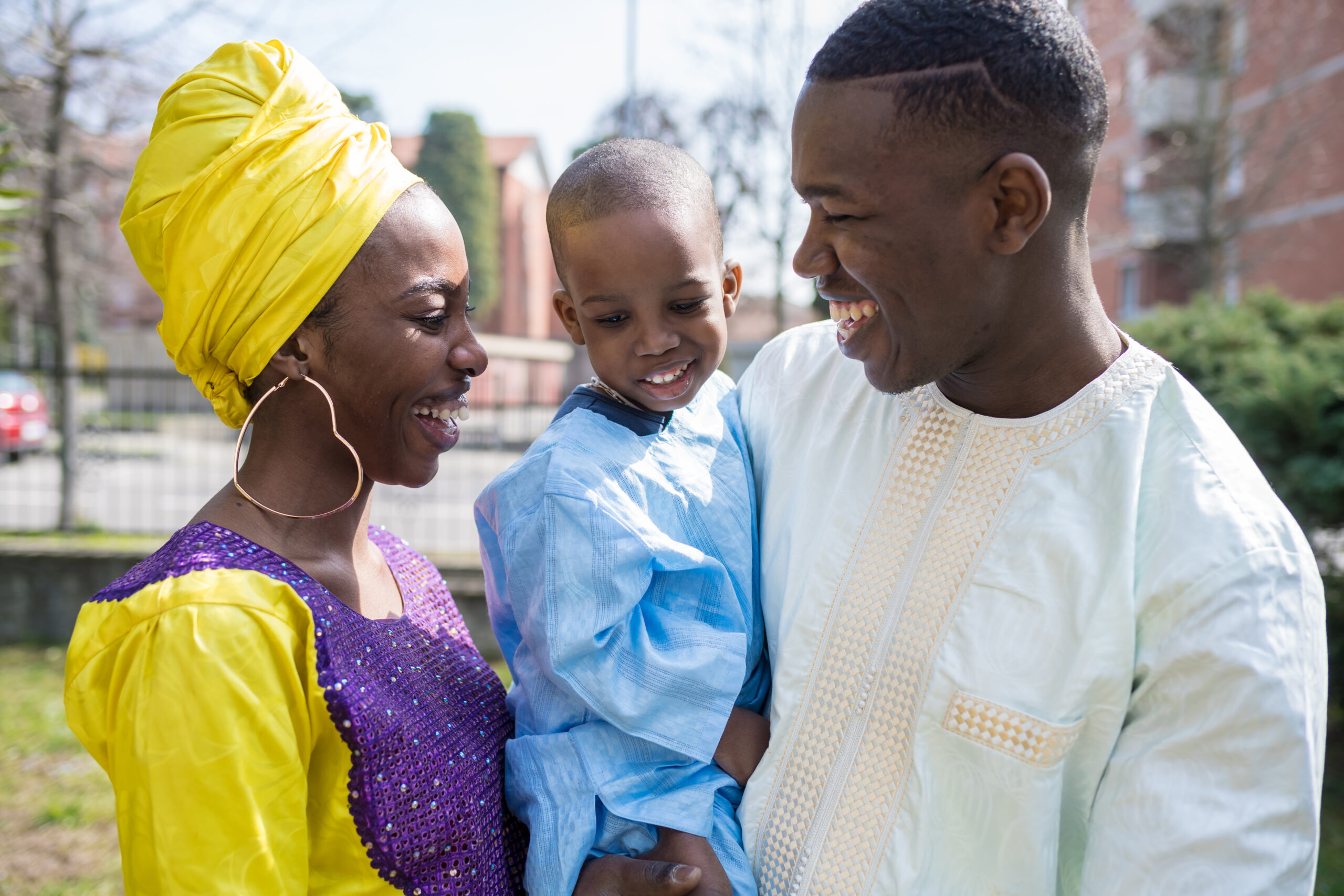 portrait happy family outdoor smiling holding their son - getting away from it all, simple living, happiness concept